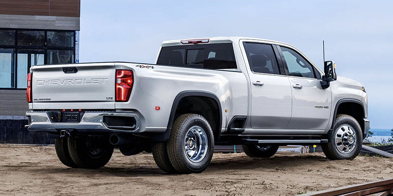 Silver Chevrolet Silverado 3500 HD parked with a view of the rear showcasing the Chevrolet logo