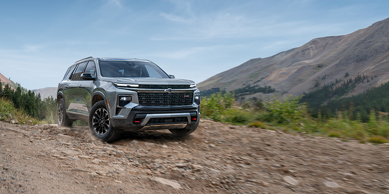 A Chevrolet Traverse driving off-road in a mountainous area.