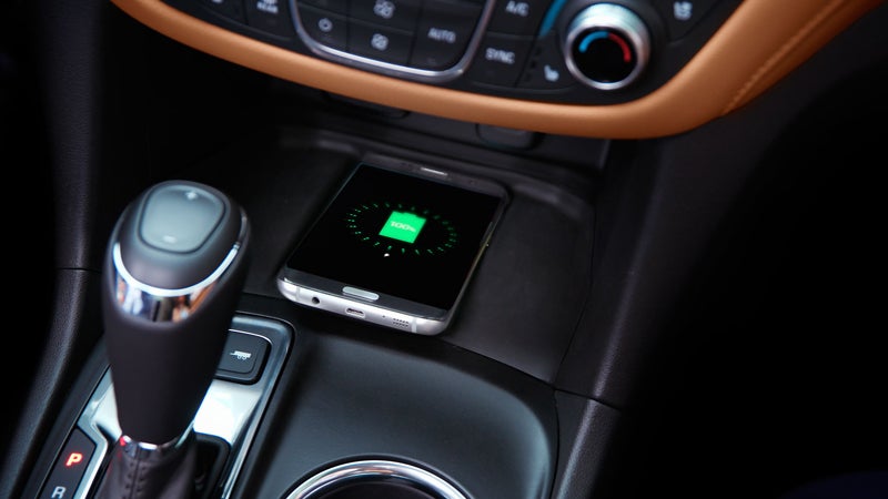 A close-up of the gear shift and wireless mobile charging pad in a Chevrolet Equinox