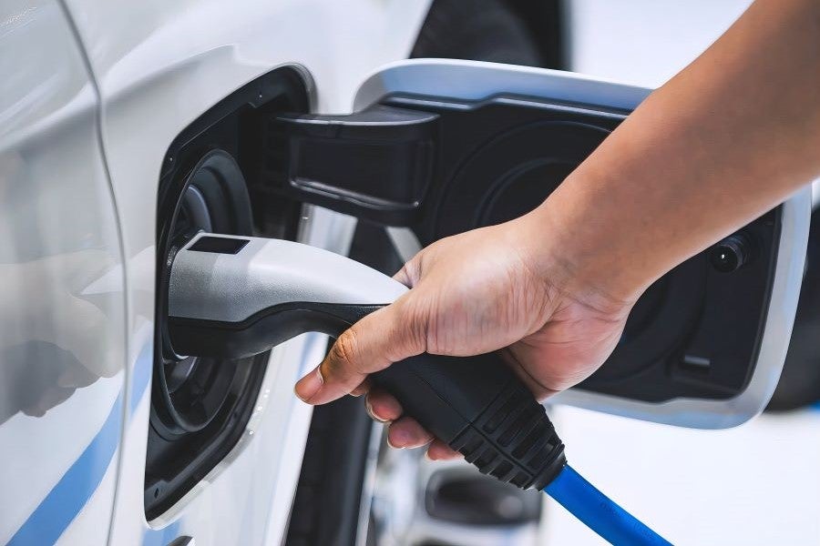 Electric car charging at an EV station