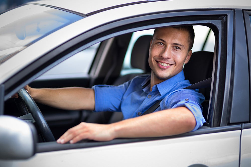 Happy man sitting in his car