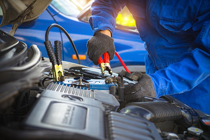Technician repairing a car batteries