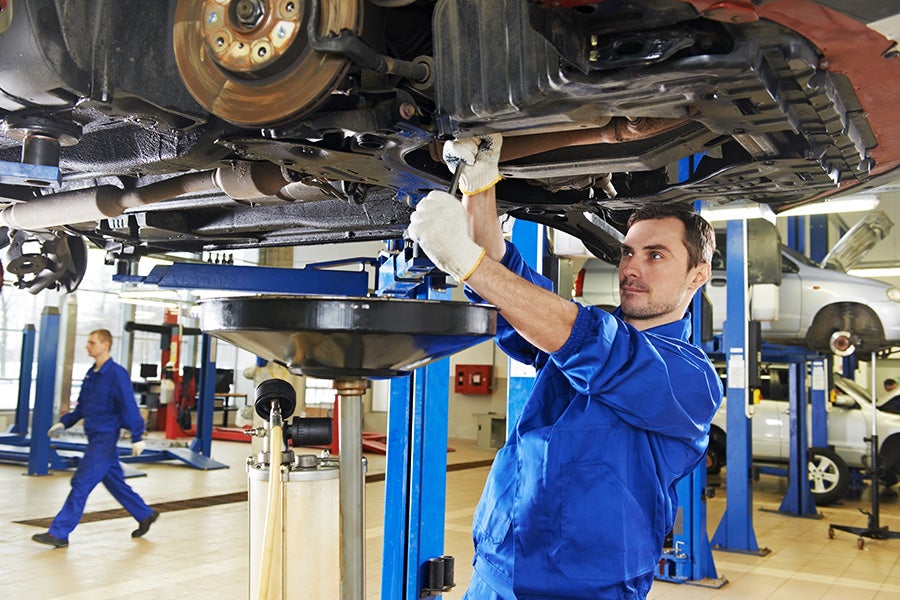 Technician servicing a car in a service center