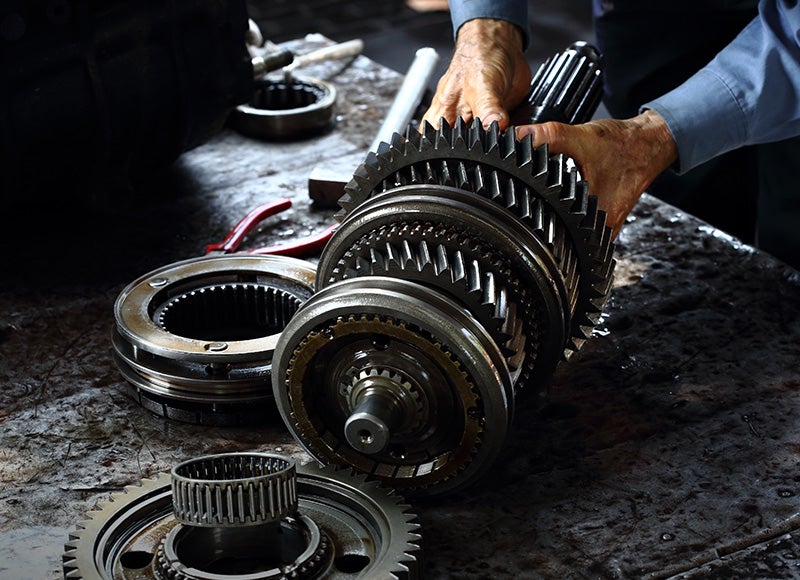 Technician repairing a transmission system